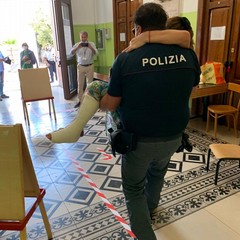 alla scuola Oberdan un poliziotto porta...in braccio una elettrice
